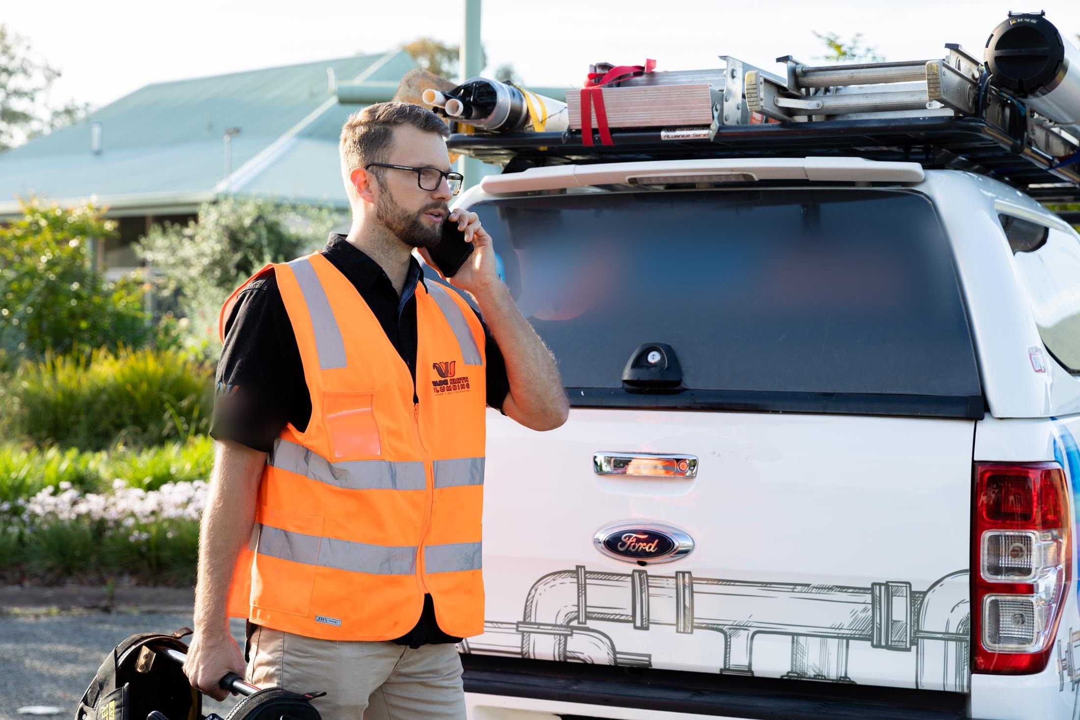 Tradie taking a call on site — the moment a missed call turns into a lost job