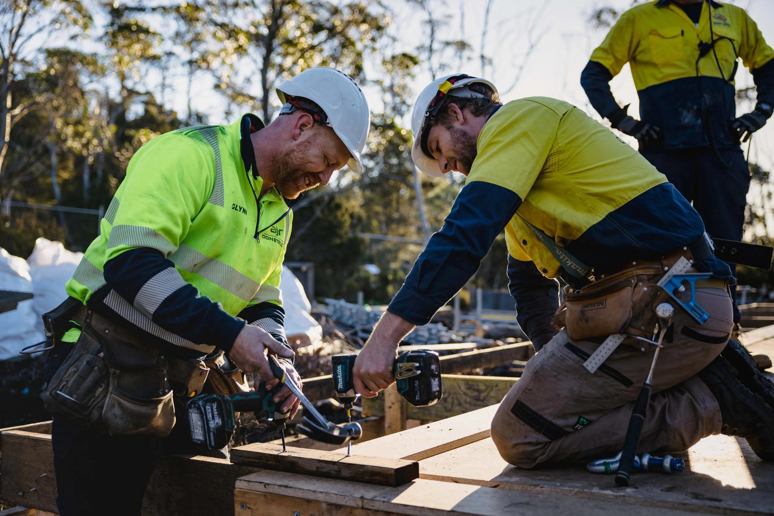 Two builders framing a job together